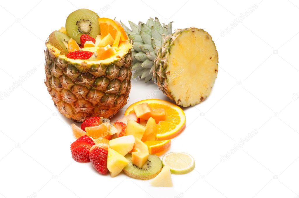 Sliced tropical fruits salad on pineapple