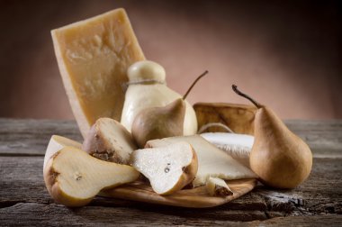 Variety of italian cheese and pears clipart