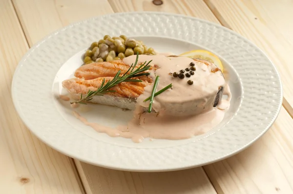 stock image Grilled fresh salmon with cream sauce and green pepper