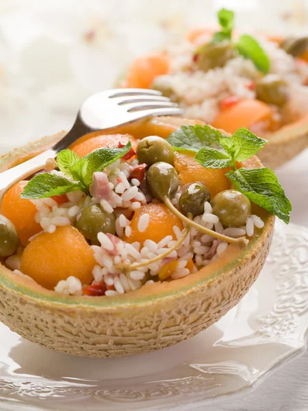 Rice salad over open melon — Stock Photo, Image