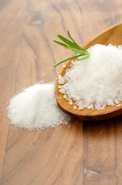 Salt over wood spoon — Stock Photo, Image