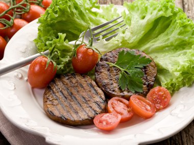 Grilled seitan with tomatoes and salad clipart