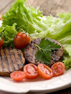 Grilled seitan with tomatoes and salad clipart