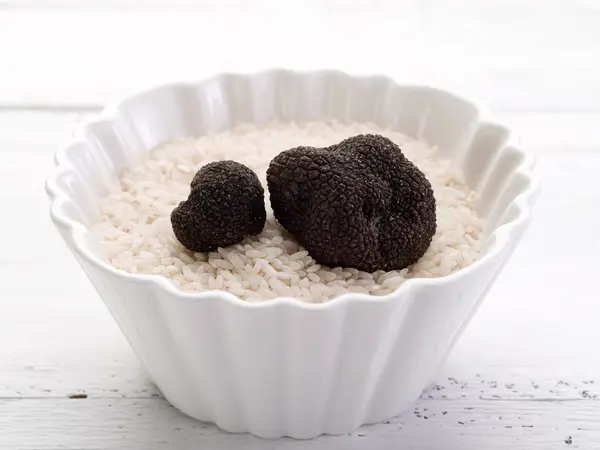 Truffle over raw rice on bowl — Stock Photo, Image