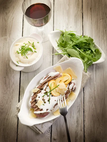 Tenderloin with cream sauce ovum mushroom and arugula salad — Stock Photo, Image