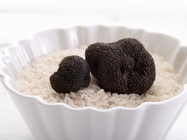 Truffle over raw rice on bowl — Stock Photo, Image