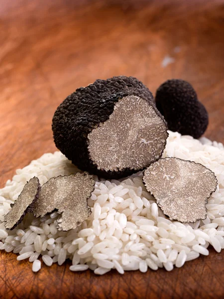 Sliced black truffle over wood background — Stock Photo, Image