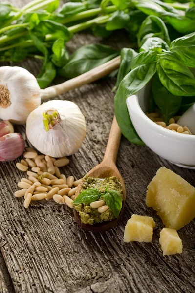 Pesto sauce with ingredients on wood background — Stock Photo, Image