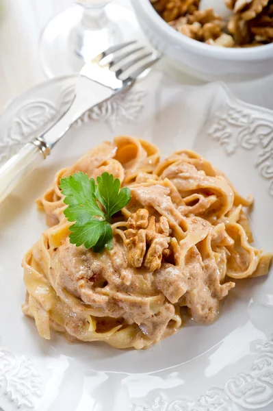 Pasta with nuts and cream sauce — Stock Photo, Image