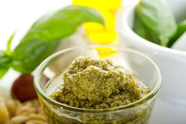 Pesto sauce with ingredients on white background — Stock Photo, Image