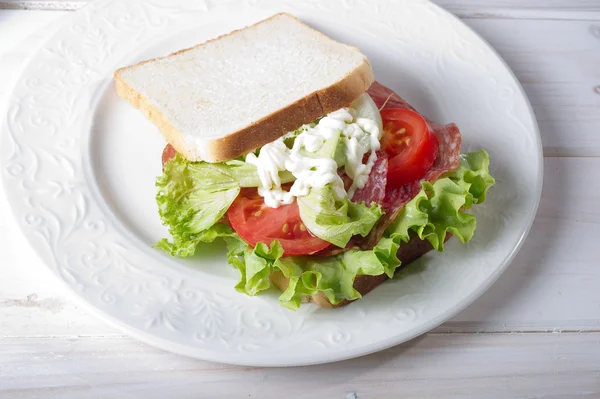 Sandwich with salami and lettuce — Stock Photo, Image