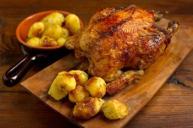 Roasted chicken with potatoes clipart