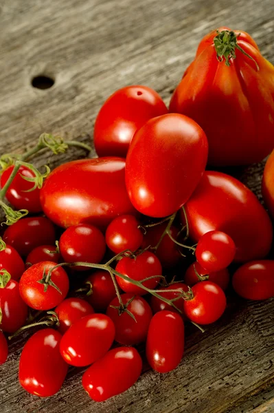 Tomatoes on wood background — Stock Photo, Image