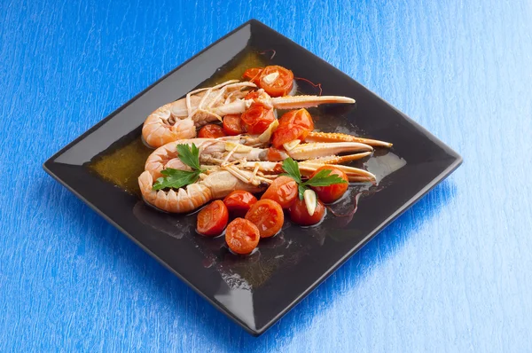 Norway lobster with sliced cherry tomatoes — Stock Photo, Image