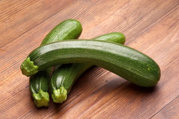 Zucchinis on wood background — Stock Photo, Image