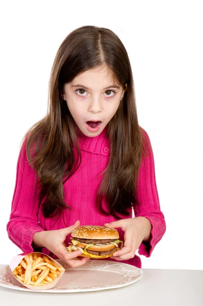 Surprise little girl looking hamburger — Stock Photo, Image