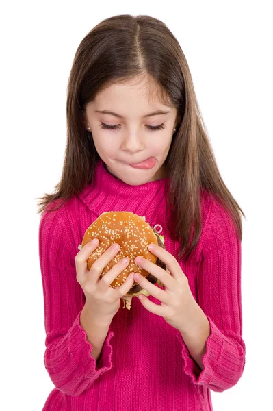 Holčička jíst hamburger — Stock fotografie