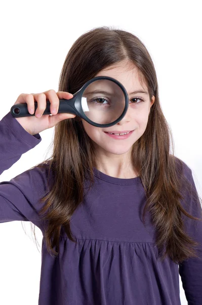 Girl holding magnifying glass — Stock Photo, Image