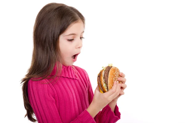 Niespodzianka mała dziewczynka, patrząc hamburgera — Zdjęcie stockowe