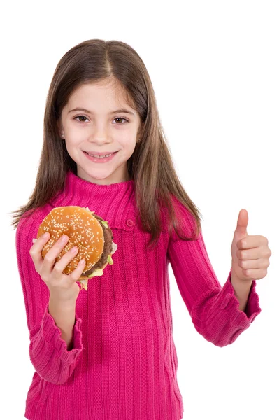 Маленькая девочка ест гамбургер — стоковое фото
