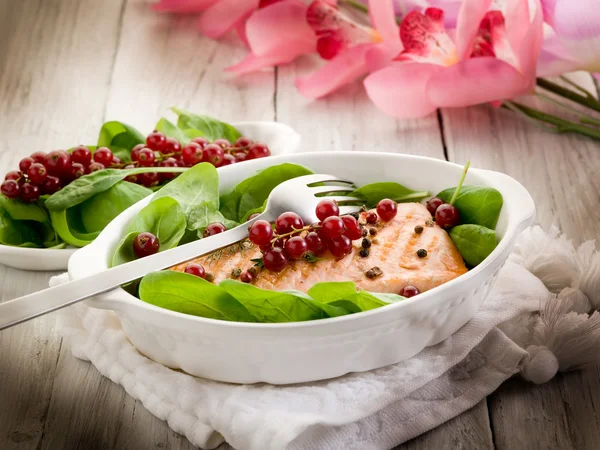 Grilled salmon with redcurrants and fresh spinach — Stock Photo, Image