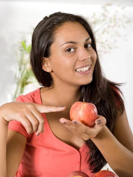 Girl with red apple at home — Stock Photo, Image