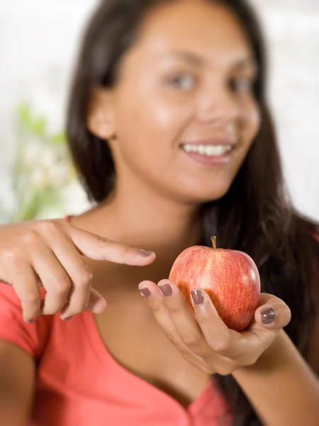 Girl with red apple at home — Stock Photo, Image