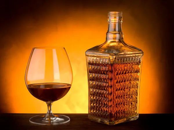 Glass and luxury bottle of liquor — Stock Photo, Image