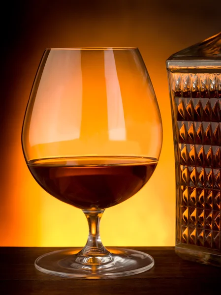 Glass and luxury bottle of liquor — Stock Photo, Image