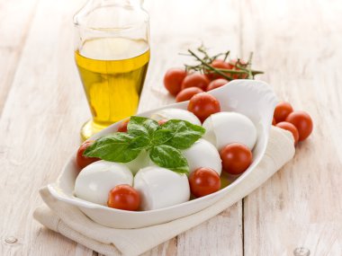 Buffalo mozzarella with basil and tomatoes clipart