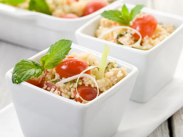 Vegetable couscous with cherry tomatoes and mint leaf — Stock Photo, Image