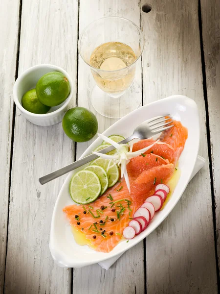 Salmon carpaccio with slice grapefruit, lime and radish — Stock Photo, Image