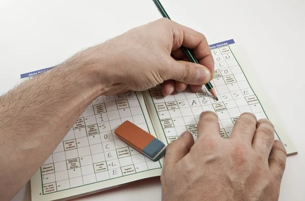Crossword game with left hand writer — Stock Photo, Image