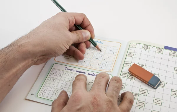 Sudoku game with left hand writer — Stock Photo, Image
