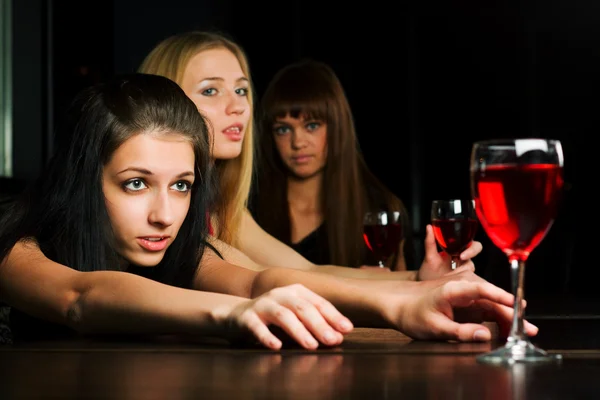 Three young women in a night bar