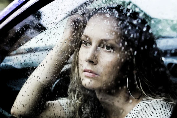 Sad woman and a rain