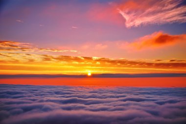 Sunset above clouds clipart