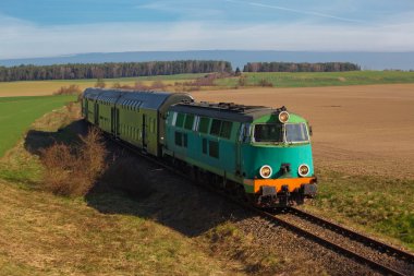 Passenger train passing through countryside clipart