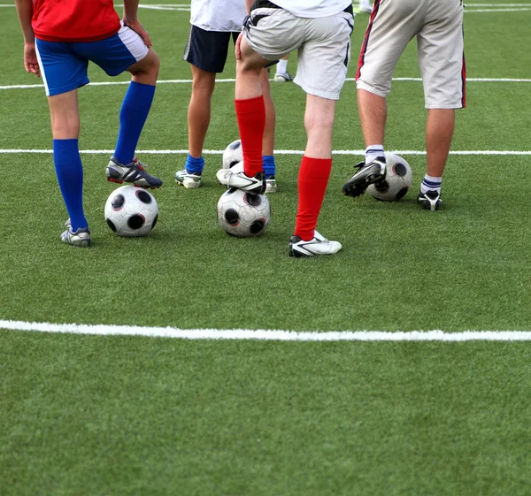 Jugadores de fútbol con el pie en un balón de fútbol —  Fotos de Stock