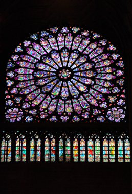 Stained glass window in Notre dame cathedral clipart