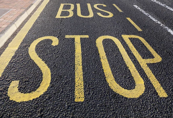 Sinal de paragem de autocarro pintado na estrada de asfalto — Fotografia de Stock