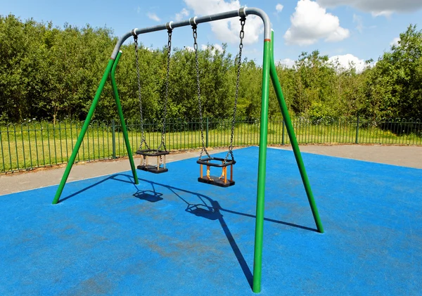 Empty swing on playground — Stock Photo, Image