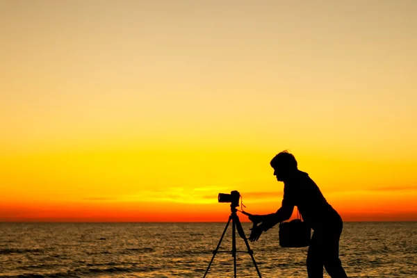 Photographer working at sunset — Stock Photo, Image