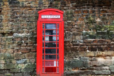 The British red phone booth on old wall clipart