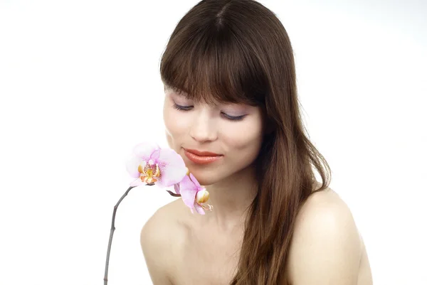 Mujer con una orquídea Fotos de stock