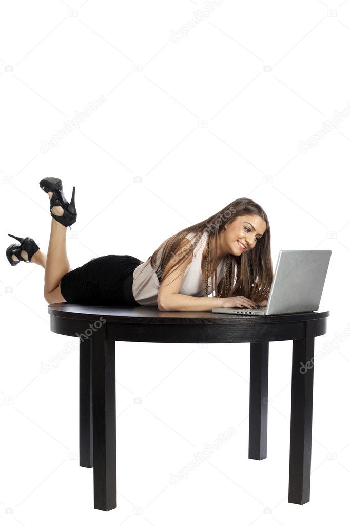 Sexy young woman working on laptop