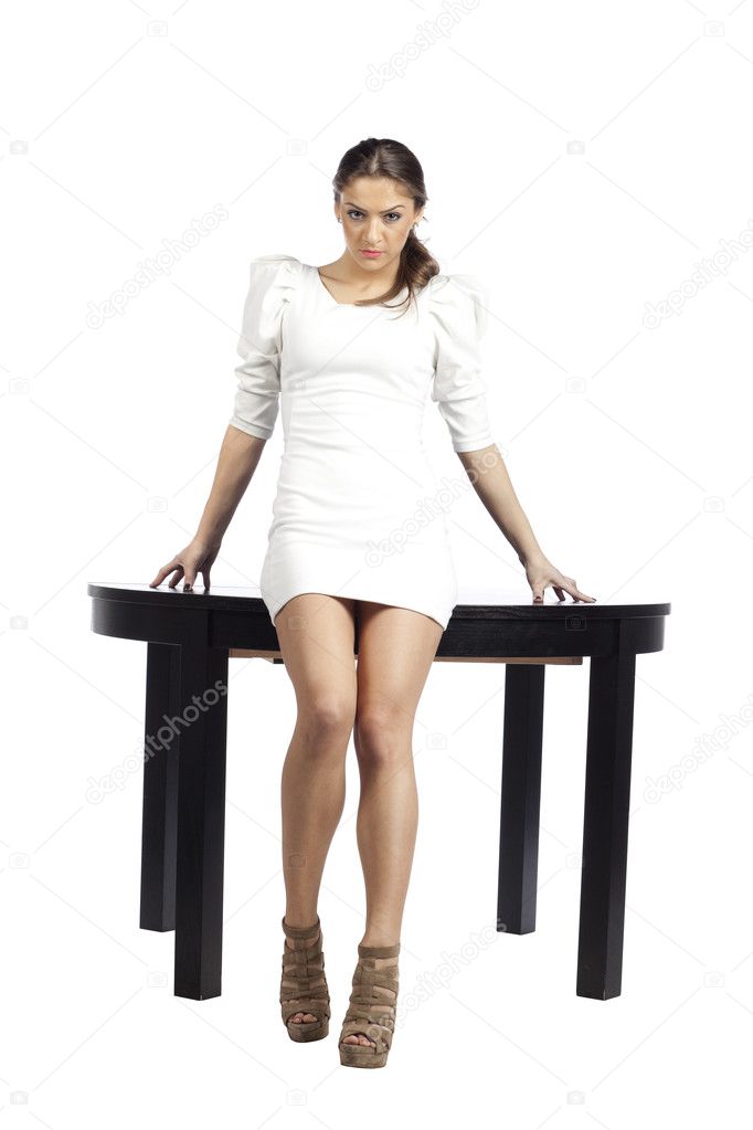 Seductive fashion model on a round table
