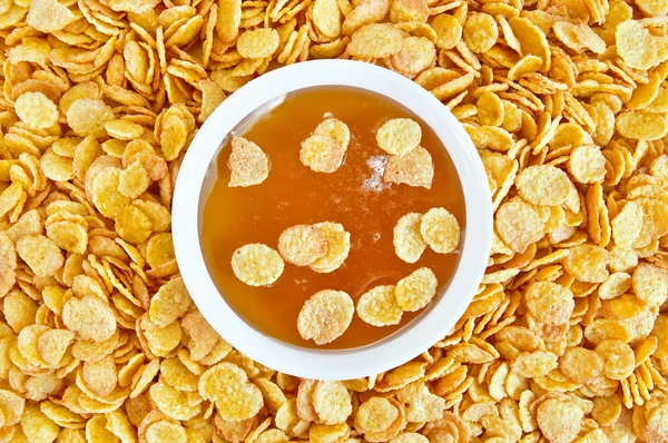 Cornflakes with honey — Stock Photo, Image