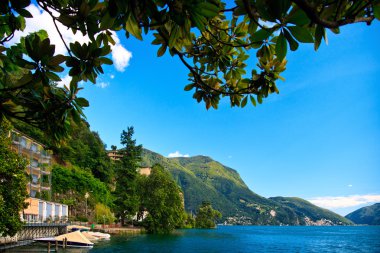 Lugano city lying on the lake Lugano clipart