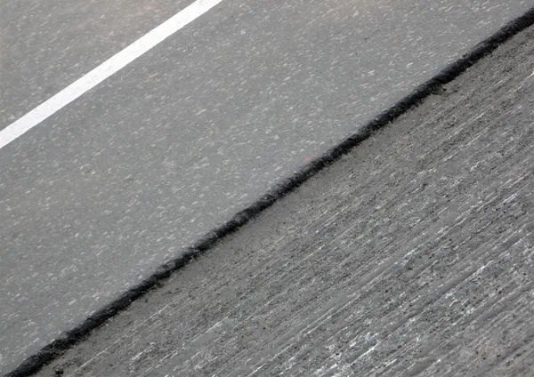 Asfalto danificado abstrato, detalhes da estrada . — Fotografia de Stock